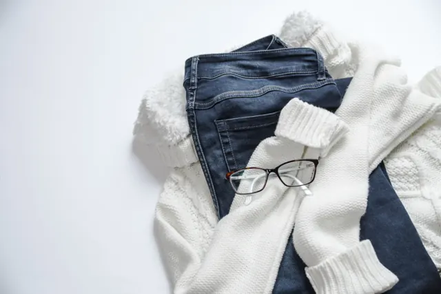 Folded jeans and a white knit sweater